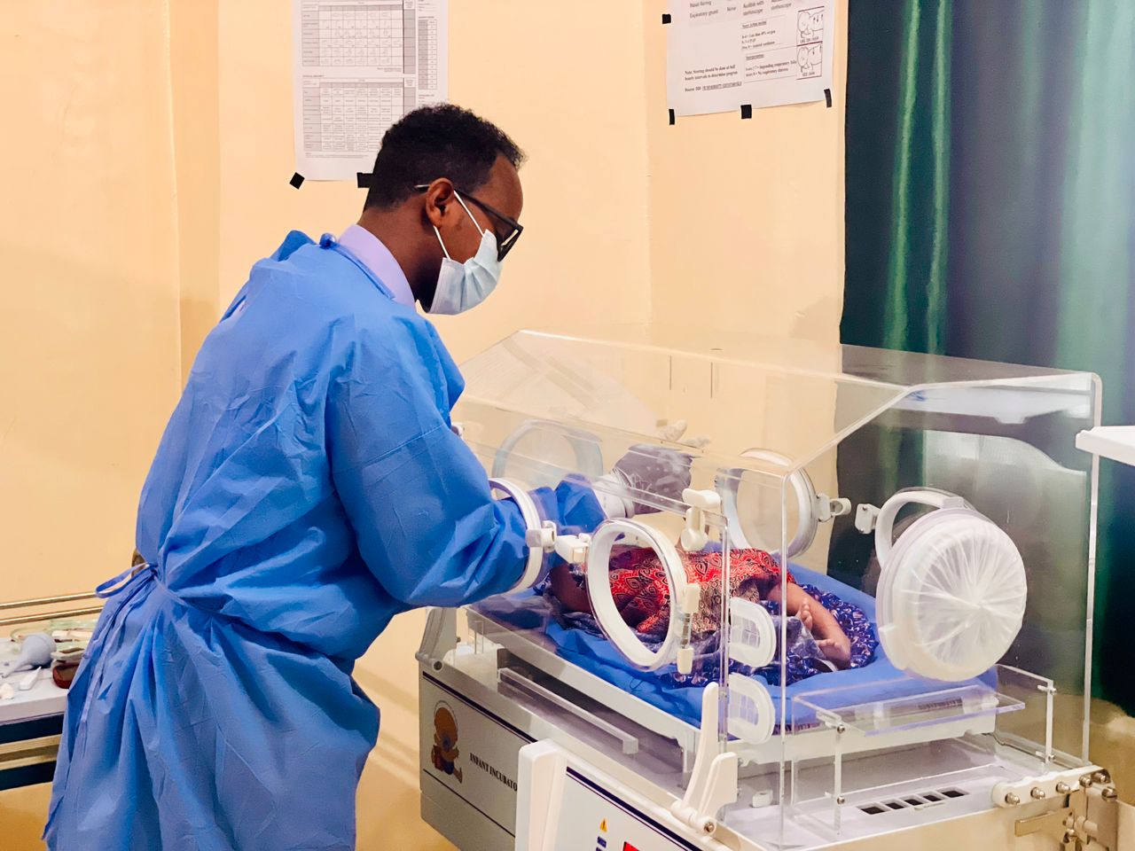 Pediatrician examining smiling child